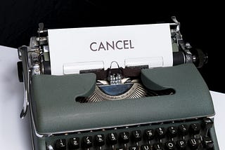 Paper with the word “CANCEL” in large print on the page in a typewriter