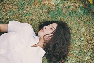 woman laid on the floor looking to the side and feeling anxious