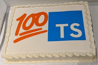 Custom cake printed with the 100 emoji next to the TypeScript logo