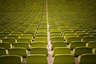 Many rows of empty yellow chairs
