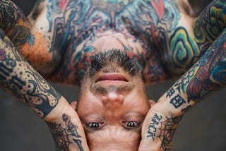 A man covered in tattoos