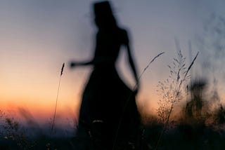 Silhouette of a woman in a meadow