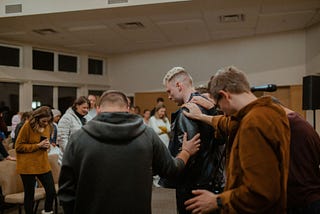 a group session bowed in prayer