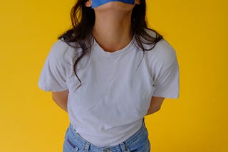 image of a woman with a piece of tape over her mouth showing censorship