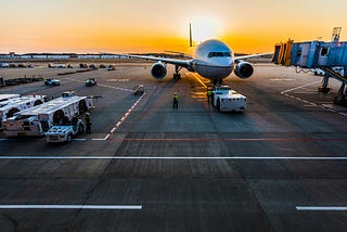 Plane in an airport at dusk.