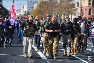 Around nine Oath Keepers marching in the street during the Million MAGA March on November 14, 2020