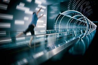 A man jumping forward towards a space age looking tunnel