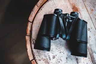 A pair of binoculars resting on a table.