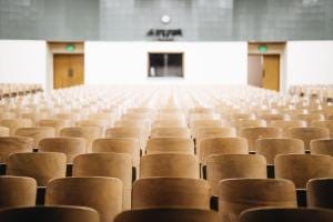 Empty auditorium with lots of chairs.