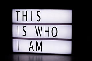 An illuminated sign with the words: ‘This is who I am’ written