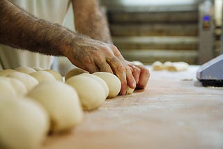 Photo of a man’s hands rolling balls of dough because that’s pretty much the sexiest thing ever.