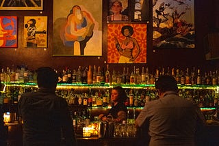 Two Guys Talking at a Bar