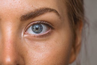 A woman with bright blue eyes looking at the camera.