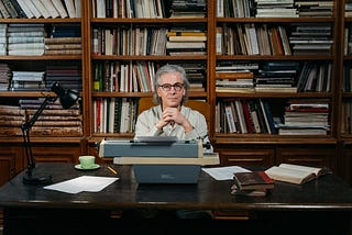 A librarian sitting at his desk with a typewriter