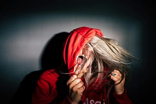 Sexy blonde woman with red hoodie screaming