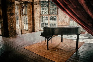 A grand piano alone in a room