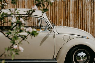 White volkswagon beetle with white flowers