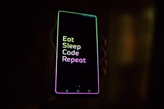 Image: Phone that says, “Eat, sleep, code, repeat.”