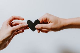 Picture of 2 people holding a heart