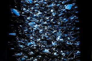 Shards of glass scattering, as if a mirror had exploded