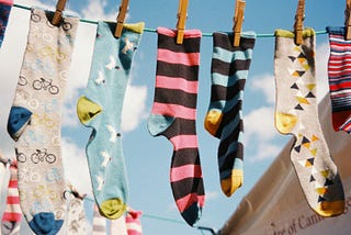 Colorful patterned socks hanging on a clothesline