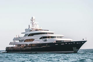A large yacht sailing through water.