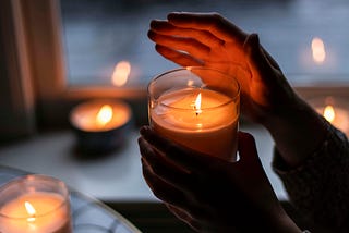 hands holding candles
