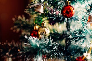 A flocked and decorated Christmas tree with bright red and gold ornaments