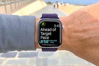 An Apple Watch being worn by a jogger telling them that they are ‘ahead of their target pace’