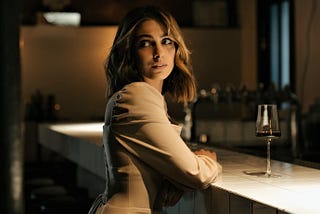 A woman at a bar glancing over her shoulder.