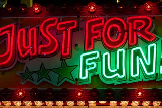 Neon sign that says JUST FOR FUN