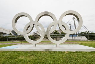 A large, metal ornamental depiction of the Olympic Rings but with no colours