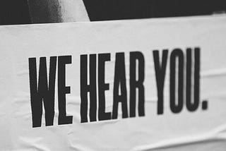 A sign saying ‘We hear you.’