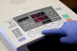 Laboratory researcher selecting the sterilization setting on a TOMY SX-700 Lab Autoclave.