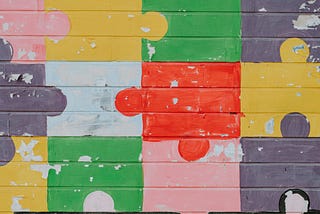 Jigsaw pattern painted on a brick wall.