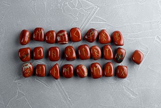 Red Rune Stones laid out in three rows with one separate from the rest