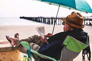 A man reading in a beachfront