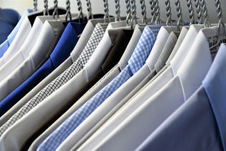 A row of shirts on hangers.