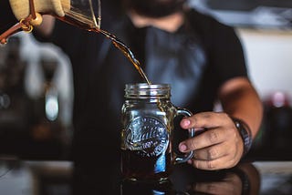 Pouring cold brew coffee into jar