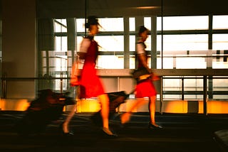 Two flight attendants rush to their next destination