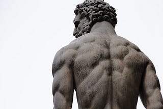 A sculpture of Hercules viewed from the back.