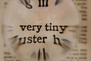 Small, blurry background text with the words “very tiny” magnified
