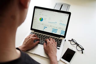 A person typing on a computer while sitting at a desk