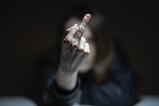 A hand gives the middle finger.