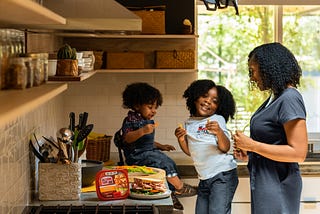 family talking together in the kitchen to illustrate the topic: conversation starters for parents