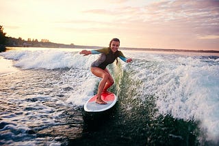 Young woman surfing the waves