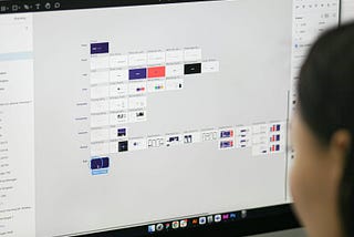 a woman is looking at a computer screen