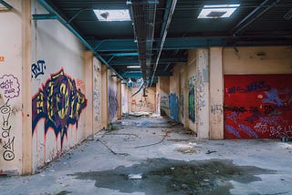 Decaying and spray painted subway station.