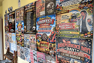 AI-created posters tacked to a wall that all look similar