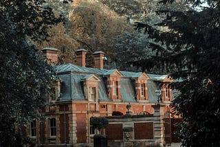 Manor house in the countryside surrounded by trees